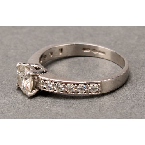 575 - A diamond ring, claw set brilliant cut stone flanked by two rows of five further stones, platinum sh... 