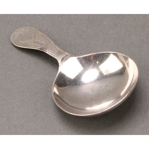 64 - A George III silver caddy spoon, the bowl engine turned with a chequered panel, outlined throughout ... 