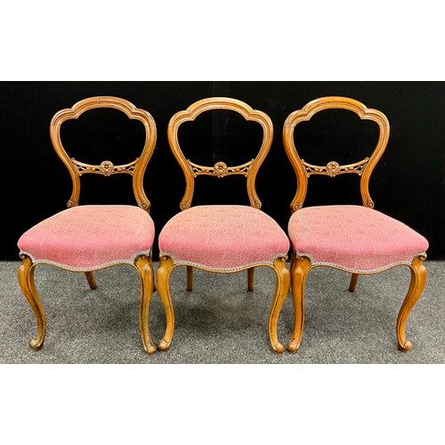 1909 - A set of three Victorian carved walnut chairs, carved balloon-backs, with pierced and carved splat, ... 