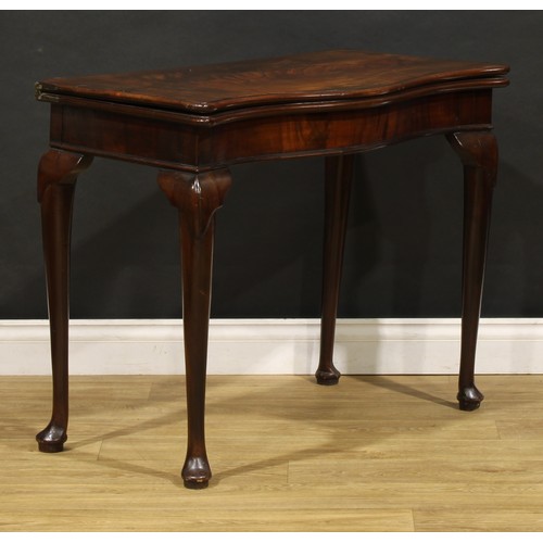 1740 - A George III mahogany serpentine card table, folding top enclosing an inset baize lined playing surf... 