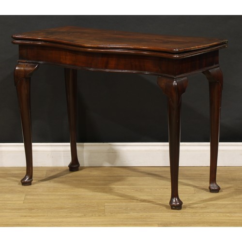 1740 - A George III mahogany serpentine card table, folding top enclosing an inset baize lined playing surf... 