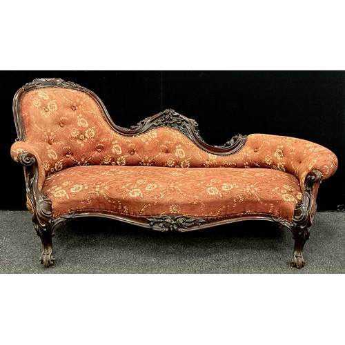 1618 - A Victorian carved walnut chaise longue, spoon-back, with Rococo style scroll arms, carved floral fr... 