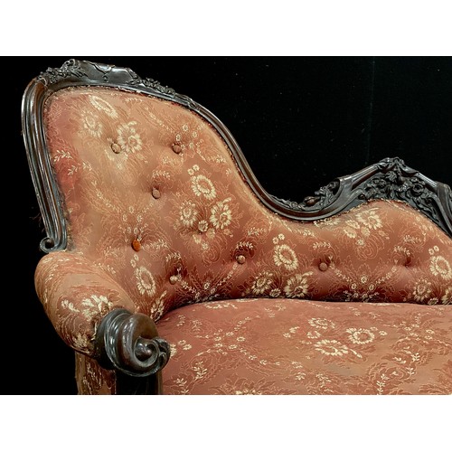 1618 - A Victorian carved walnut chaise longue, spoon-back, with Rococo style scroll arms, carved floral fr... 