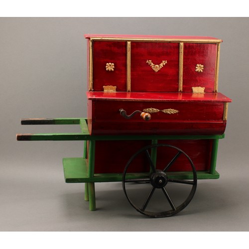 2051 - An early 20th century novelty music box, as a barrel organ on trolley, the mechanism playing 4.5