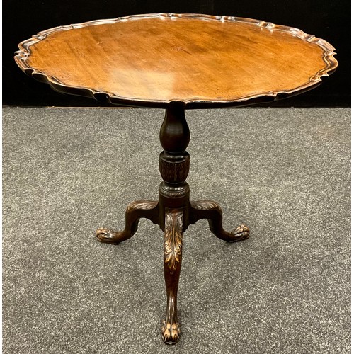 1670 - A 19th century mahogany tilt-top table, the shaped recessed circular top, supported by a baluster fo... 