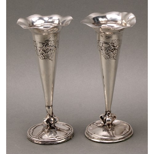 149 - A pair of Art Nouveau silver flower vases, each embossed with stylised flowers, wavy everted rims, s... 