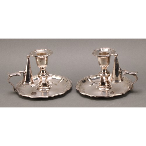 38 - A pair of late Victorian E.P.N.S chambersticks, of George II design, bell shaped sconces with detach... 