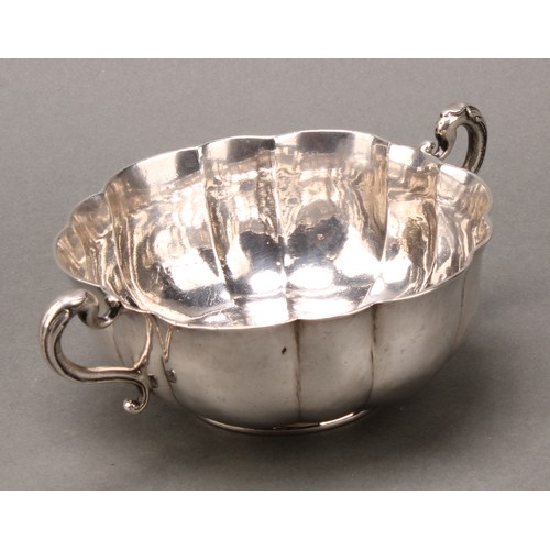 416 - A Spanish Colonial South American silver fluted two-handled bowl, the interior chased with a flower,... 