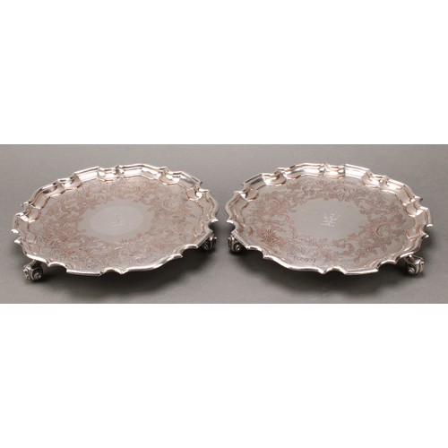 36 - A pair of George/William IV Old Sheffield Plate shaped circular salvers, each chased with a Rococo b... 