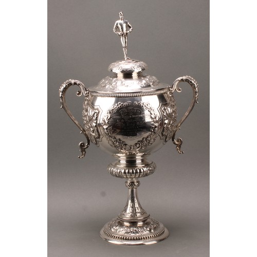 429 - A substantial Victorian silver two-handled pedestal trophy cup and cover, of military interest, surm... 