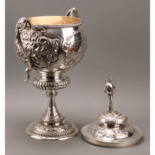 429 - A substantial Victorian silver two-handled pedestal trophy cup and cover, of military interest, surm... 