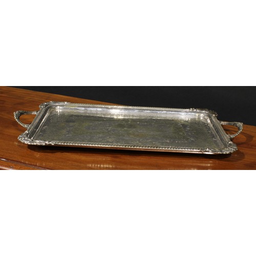 43 - A Victorian E.P.N.S rectangular serving tray, the field engraved with bands of leafy scrolls and flo... 