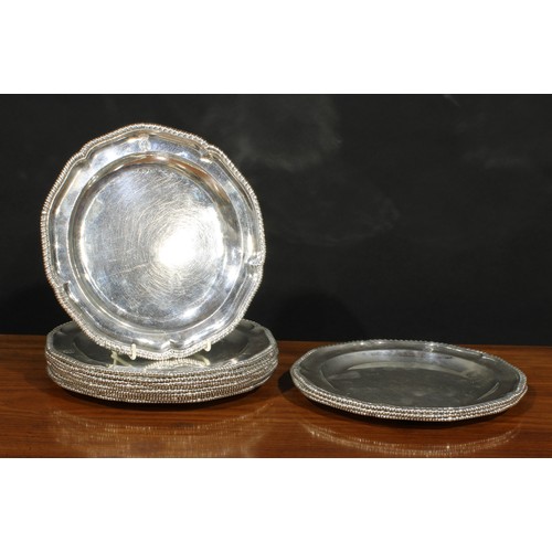 409 - A set of twelve George III silver shaped circular dinner plates, gadrooned borders, 24.5cm diam, som... 