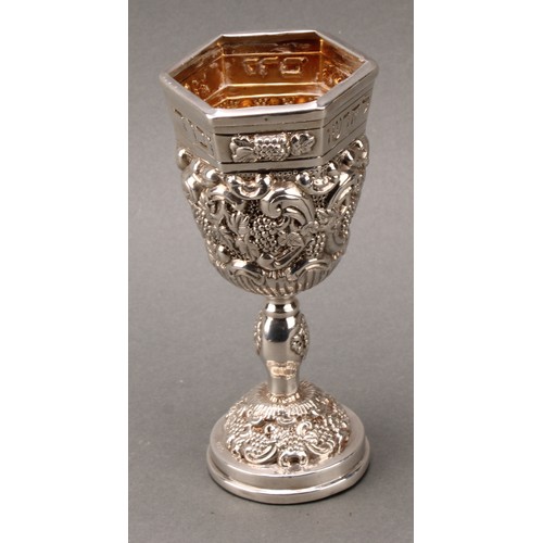 185 - Judaica - a pair of Jewish silver Kiddush cups, profuesly chased with fruiting vine, gilt interiors,... 