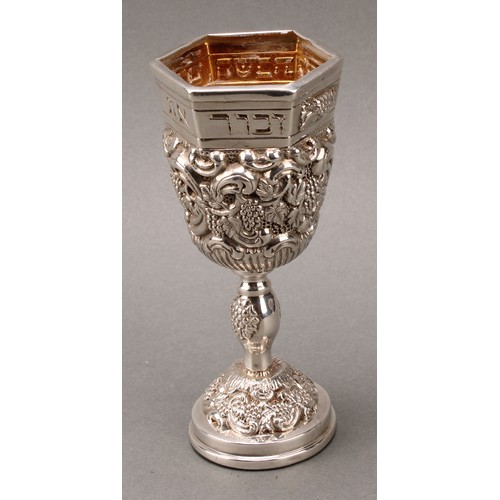 185 - Judaica - a pair of Jewish silver Kiddush cups, profuesly chased with fruiting vine, gilt interiors,... 