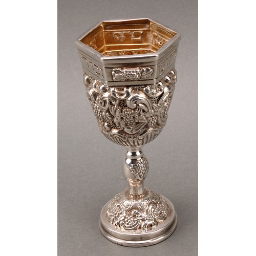 185 - Judaica - a pair of Jewish silver Kiddush cups, profuesly chased with fruiting vine, gilt interiors,... 