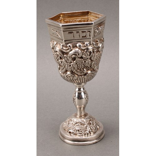 185 - Judaica - a pair of Jewish silver Kiddush cups, profuesly chased with fruiting vine, gilt interiors,... 