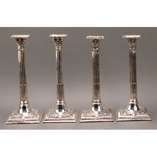 208 - A set of four early George III cast silver Corinthian column table candlesticks, detachable nozzles,... 