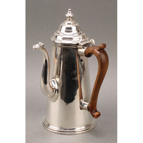 162 - A Queen Anne silver conical side handled chocolate pot, hinged cover with stirring aperture, S-shape... 