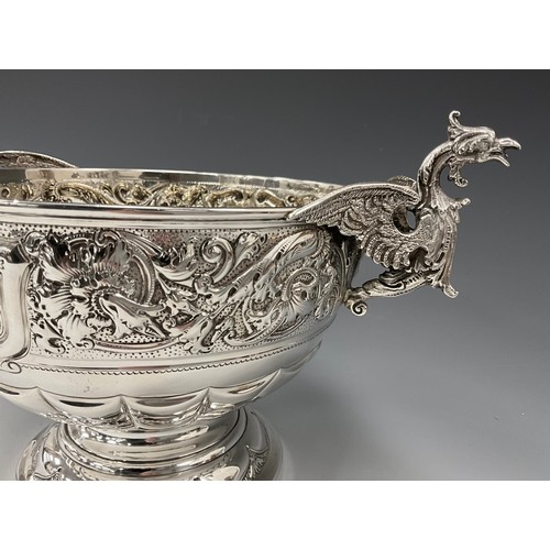 142 - A late Victorian silver twin handled pedestal bowl, griffin handles, embossed floral collar, vacant ... 