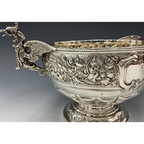 142 - A late Victorian silver twin handled pedestal bowl, griffin handles, embossed floral collar, vacant ... 