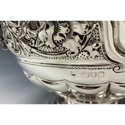 142 - A late Victorian silver twin handled pedestal bowl, griffin handles, embossed floral collar, vacant ... 