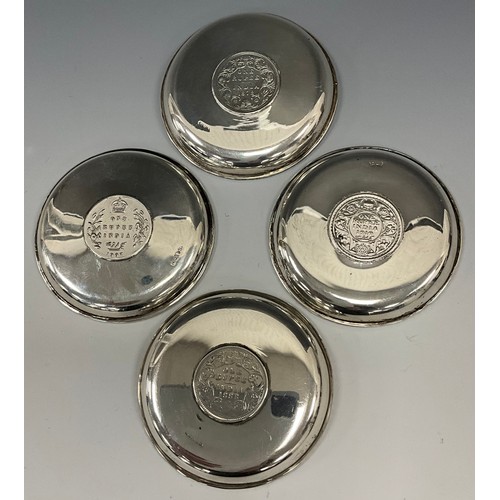 399 - A set of four silver Indian coin pin dishes, each marked one Rupee, dates, 1878, 1888, 1907, 1919, 8... 