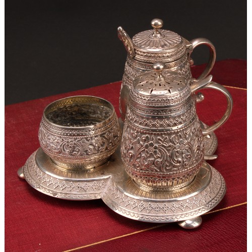 320 - A Victorian silver trefoil cruet, chased in the Indian taste with flowers and dense scrolling foliag... 