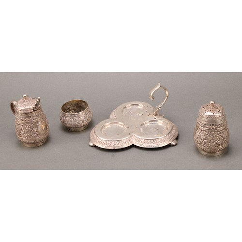 320 - A Victorian silver trefoil cruet, chased in the Indian taste with flowers and dense scrolling foliag... 