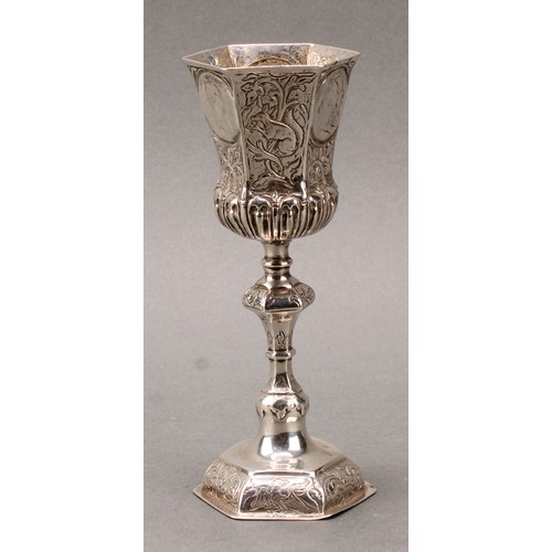 94 - A German silver pedestal cup, hexagonal bell shaped bowl set with coins, knopped stem, domed foot ch... 