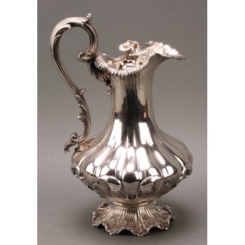 437 - A William IV Rococo Revival silver fluted pedestal wine ewer, hinged cover with flower finial, acant... 