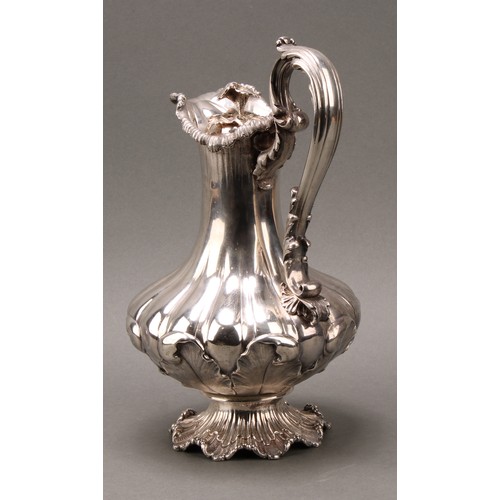 437 - A William IV Rococo Revival silver fluted pedestal wine ewer, hinged cover with flower finial, acant... 