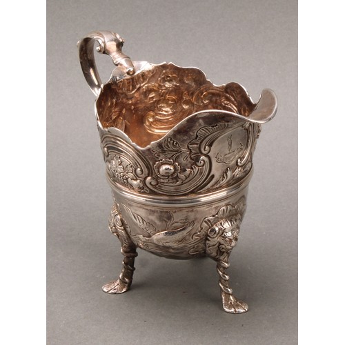 445 - An 18th century Irish silver cream jug, of bold design, chased with ducks taking to flight, flowers,... 