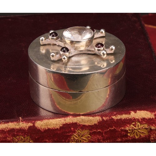 194 - Modern Design - an Elizabeth II silver cylindrical box, the push-fitting cover with stone-set kineti... 