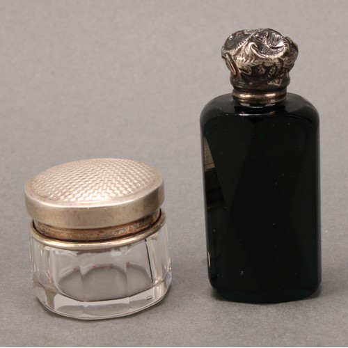 113 - A 19th century silver coloured metal mounted scent bottle, screw-fitting cover chased with a flowerh... 