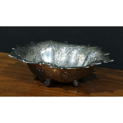 44 - A Victorian E.P.N.S shaped circular swing handled cake dish, 26cm diam, c.1870; another, embossed wi... 