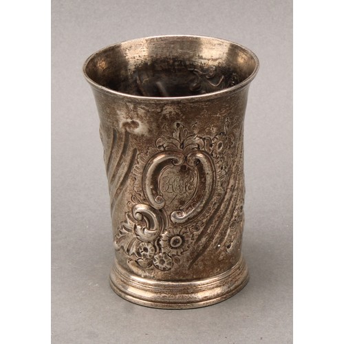 463 - An early George III silver beaker, spirally fluted and chased with flowers and foliage, skirted base... 