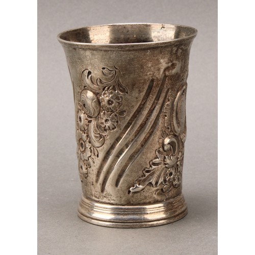 463 - An early George III silver beaker, spirally fluted and chased with flowers and foliage, skirted base... 