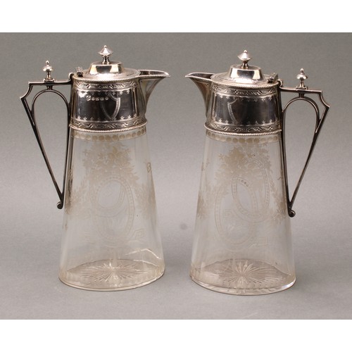 198 - A pair of Victorian silver mounted oval claret jugs, bright-cut engraved and etched in the Neo-Class... 