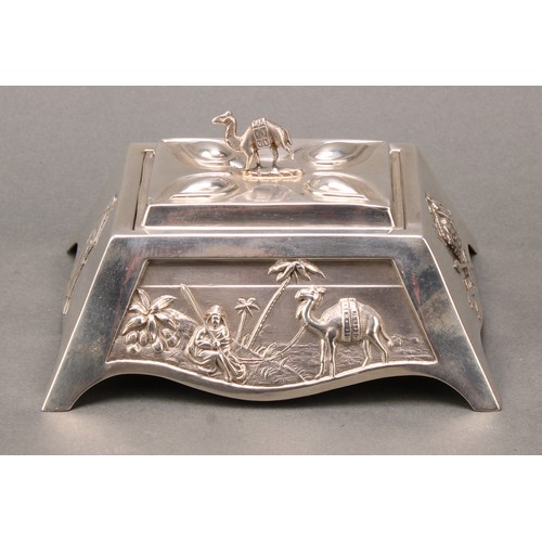 289 - An unusual silver table box, the angular sides embossed with various panels, Nile scene with palm tr... 