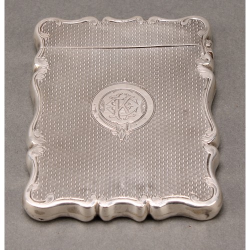 281 - A Victorian silver shaped rectangular visiting card case, engine turned, 9cm long, Cohen & Charles, ... 