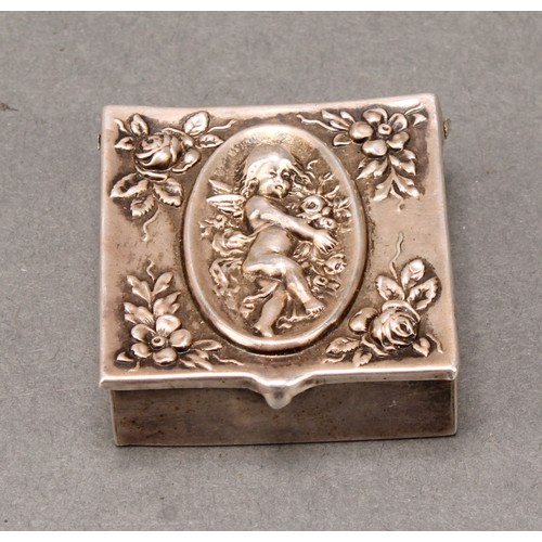 457 - An early 20th century American silver stamp box, hinged cover embossed with a putto amongst flowers,... 