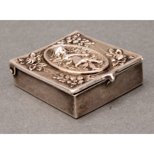 457 - An early 20th century American silver stamp box, hinged cover embossed with a putto amongst flowers,... 