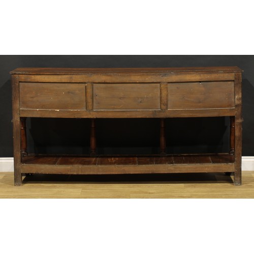 1543 - A George III and later oak low pot board dresser, slightly oversailing top above an arrangement of f... 