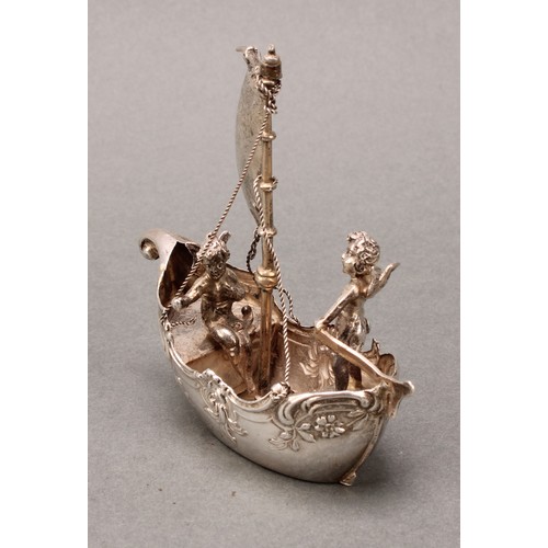 230 - Silver Toys and Miniatures - a Continental silver coloured metal novelty model, of putti sailing a s... 