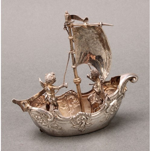 230 - Silver Toys and Miniatures - a Continental silver coloured metal novelty model, of putti sailing a s... 