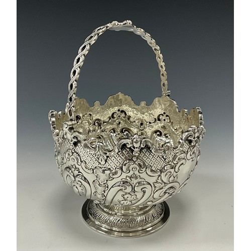 285 - A Victorian silver swing handled sugar bowl, deeply embossed with acanthus, scrolls and scaled motif... 