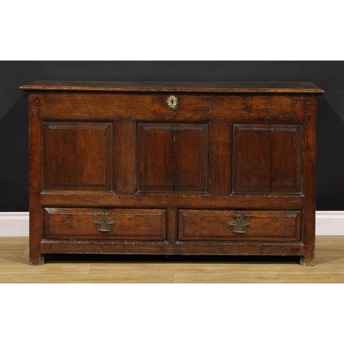 1896 - A George III oak mule chest, hinged top above a three panel front and two short drawers, 79cm high, ... 