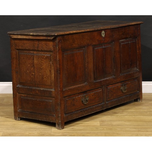 1896 - A George III oak mule chest, hinged top above a three panel front and two short drawers, 79cm high, ... 