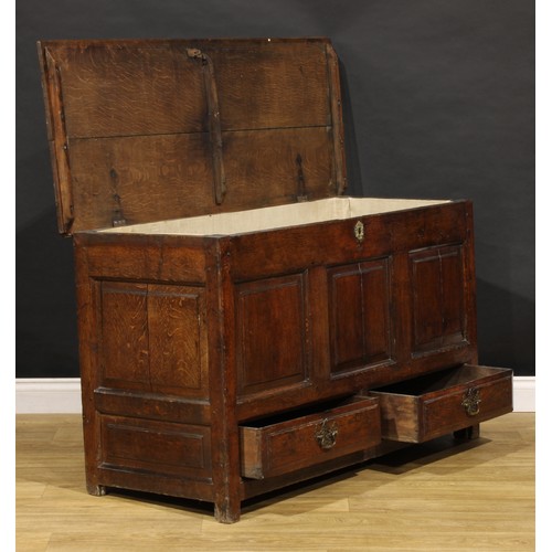 1896 - A George III oak mule chest, hinged top above a three panel front and two short drawers, 79cm high, ... 